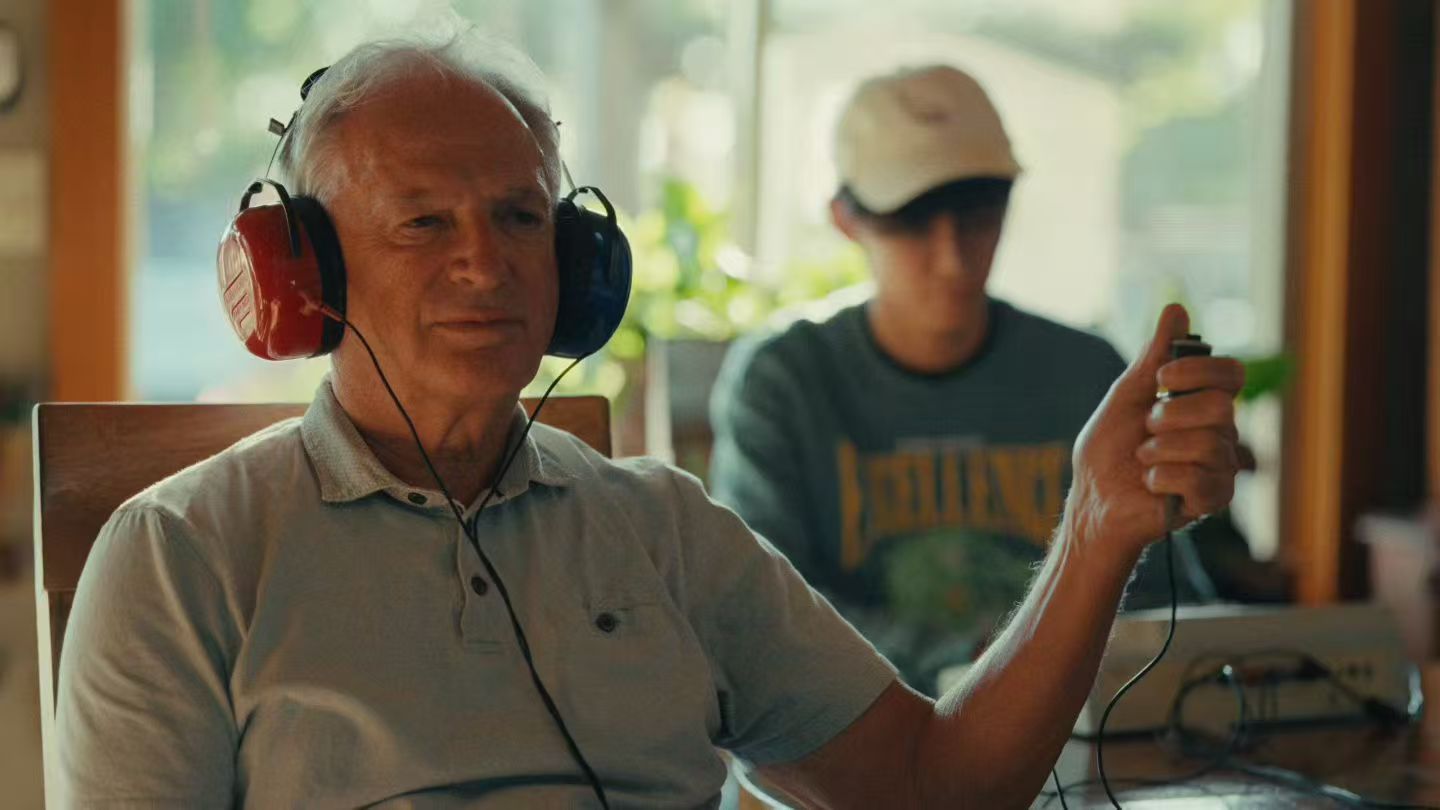 An older man wearing headphones during a listening session