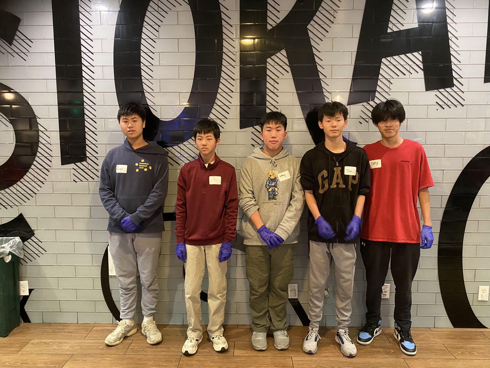 Five volunteers standing together for a team photo